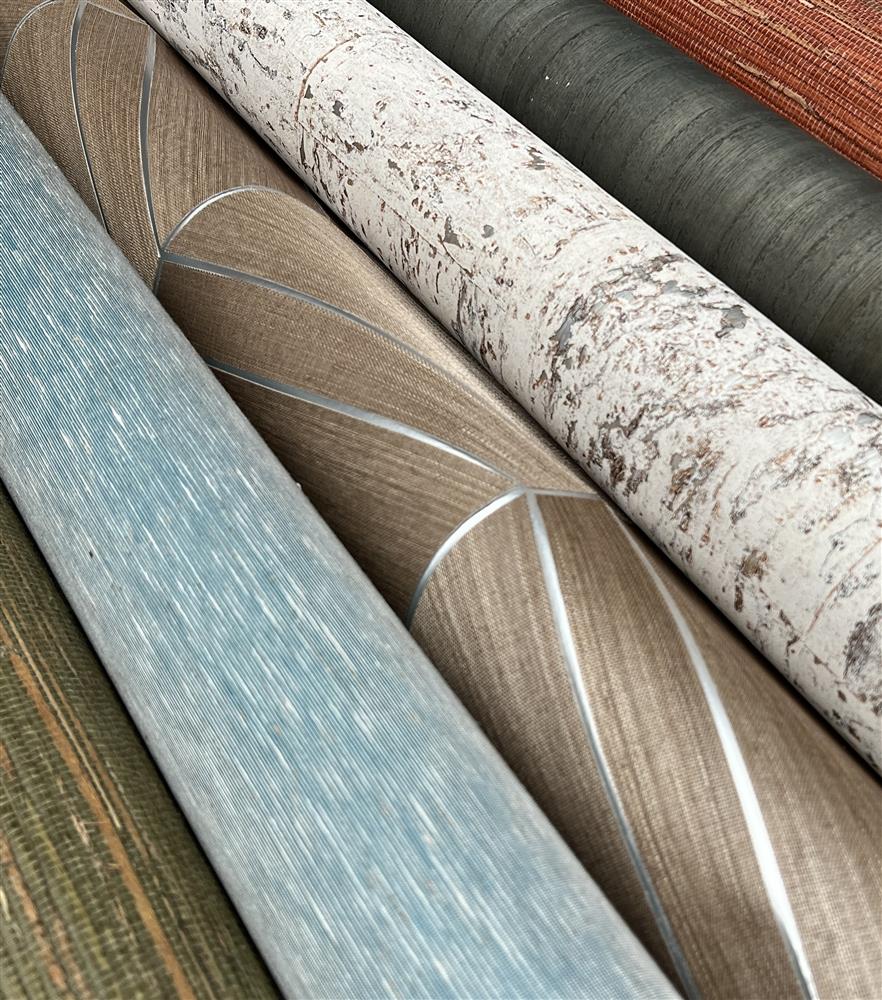 Assorted wallcovering rolls with varied textures and colors